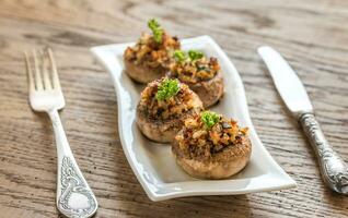 Mushrooms' caps stuffed with mixture of cheese, onion, breadcrum photo