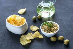 Potato chips with olive pate photo
