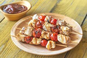 Grilled chicken skewers on the plate photo