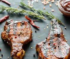 Grilled pork ribs on the wooden background photo