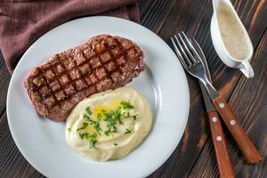 Strip steak with celery puree photo