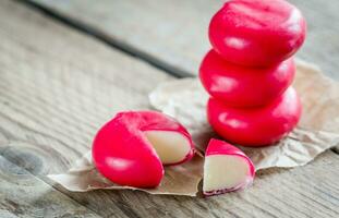 Stack of mini cheese on the wooden table photo