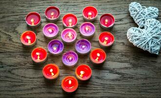 Burning candles with retro cane hearts photo