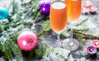 Two glasses of champagne with Christmas tree branch photo