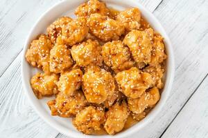 Bowl of orange chicken photo