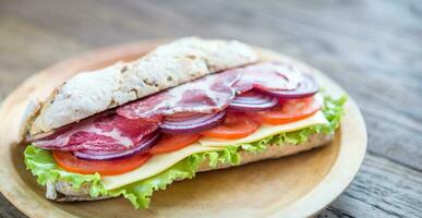 Sandwich with ham, cheese and fresh vegetables photo