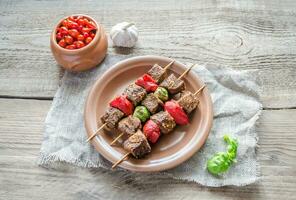 Grilled beef skewers with pepper and brussels photo