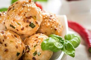 Chicken meatballs under sweet chili pepper sauce photo