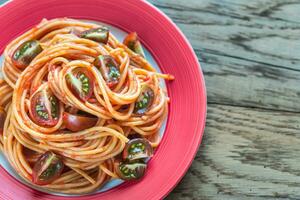 Portion of spaghetti with cherry tomatoes photo