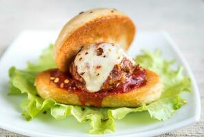 Sandwich with meatball in tomato sauce and mozzarella photo