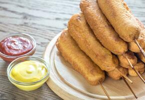 Stack of corn dogs on the wooden board photo