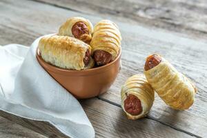 Bowl with sausage rolls photo