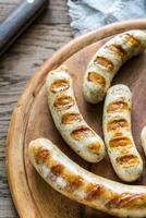 Grilled sausages on the wooden board photo