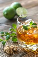 Glass of rum on the wooden background photo