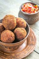 Bowl of meatballs with mexican sauce salsa photo