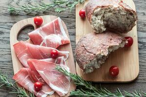 Slices of jamon on the wooden board photo