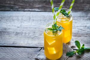 Glass jars of mango juice photo