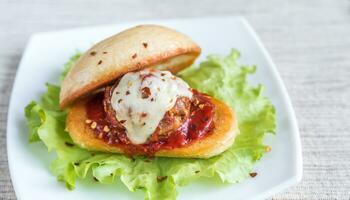 Sandwich with meatball in tomato sauce and mozzarella photo