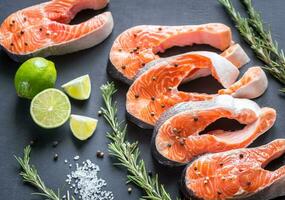 Raw trout steaks on the wooden board photo