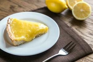 Slice of lemon tart on the plate photo