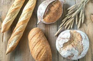 Different kinds of bread on the wooden background photo