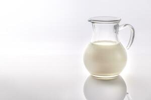 A jug of milk on the white background photo