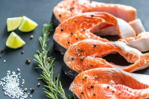 Raw trout steaks on the wooden board photo