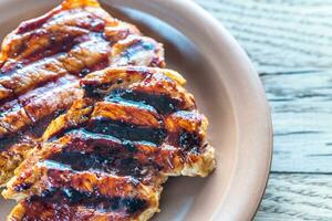 Grilled pork steaks on the plate photo