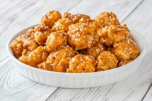 Bowl of orange chicken photo