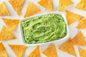 Bowl of guacamole with tortilla chips photo