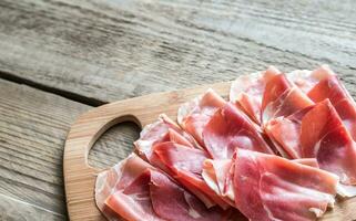 Slices of jamon on the wooden board photo