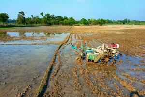 tractor or power tiller the field is plowed with modern farmer concept photo