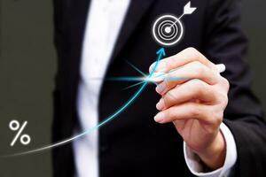 Businessman touching graph target on a virtual screen using a stylus pen. Concept of Technology and future document management. photo