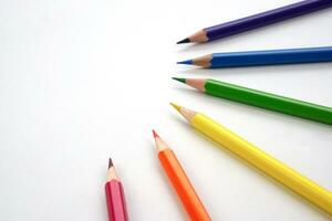 Top view of colored pencils or pastel on white background. Learning, study and presentation concept. photo