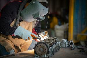 Welder is welding Tungsten Inert Gas welding, Welding aluminum with aluminum argon, TIG welding torch. photo