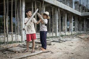 Concept of child labor, poor children being victims of construction labor, human trafficking, child abuse. photo