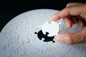 Closeup hand of woman connecting jigsaw puzzle, Business solutions, success and strategy concept photo