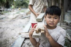 Concept of child labor, poor children being victims of construction labor, human trafficking, child abuse. photo