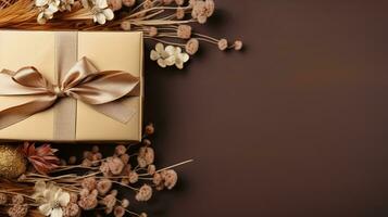 AI generated Golden gift box with shiny bow with dry flowers decor on brown background with copy space. Festive banner template photo