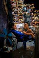 Jakarta, Indonesia - October 2 2023. Child Tending Shoe Store Night Market photo