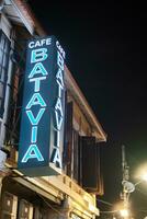 Jakarta, Indonesia - October 2 2023. Cafe Batavia Signboard Light Up at Night photo