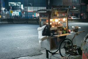 Jakarta, Indonesia - October 2 2023. Unattended Street Food Cart at Night photo