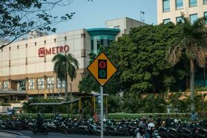 Jakarta, Indonesia - October 4 2023. Yellow Traffic Light Sign Post photo