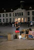 Jakarta, Indonesia - October 2 2023. Street Busker Dancing to Music photo