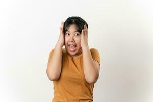 The pretty Asian young woman with surprise and shocked facial expression standing on a white background. photo