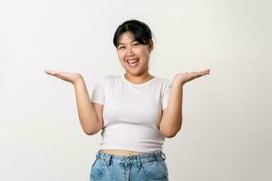 The portrait of beautiful young Asian woman hands up to product present, or showing something on white background. photo