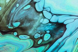 Fluid Art. Blue, green and black swirls. Abstract marble background or texture photo