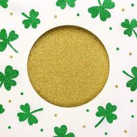 Happy St.Patricks Day background. Golden round hole and shiny green shamrocks pattern. Shiny St. Patricks Day postcard template photo