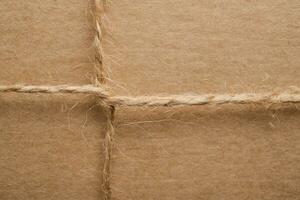 Top view of a craft gift box tied with twine, zero waste gift packaging closeup photo