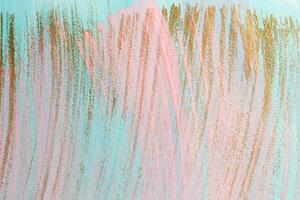 Pink and gold paint brush strokes on blue background. Hand painted background or texture for your design photo